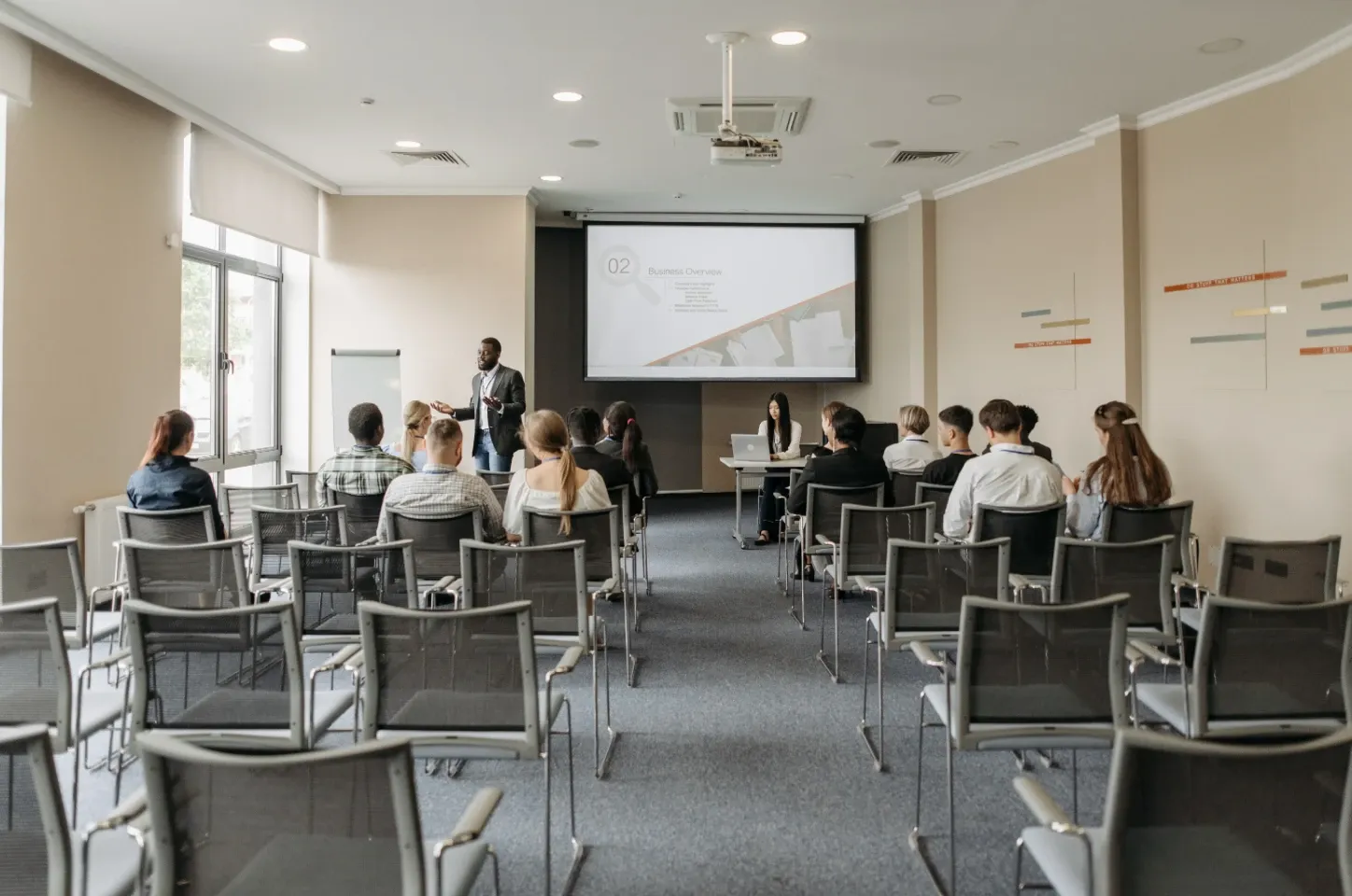 A team session running in a private conference room, screen and seating set up for the group